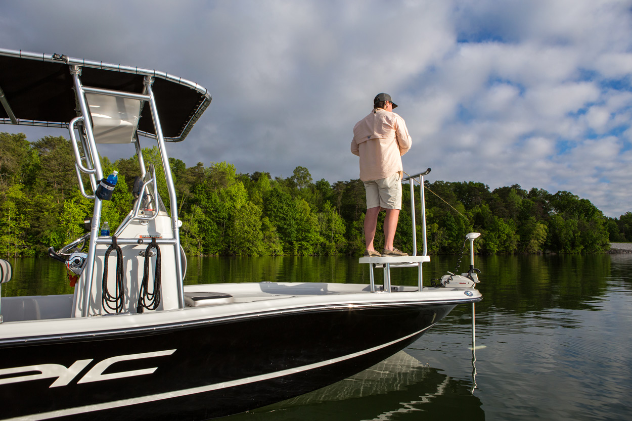 man standing on fishmaster casting platform